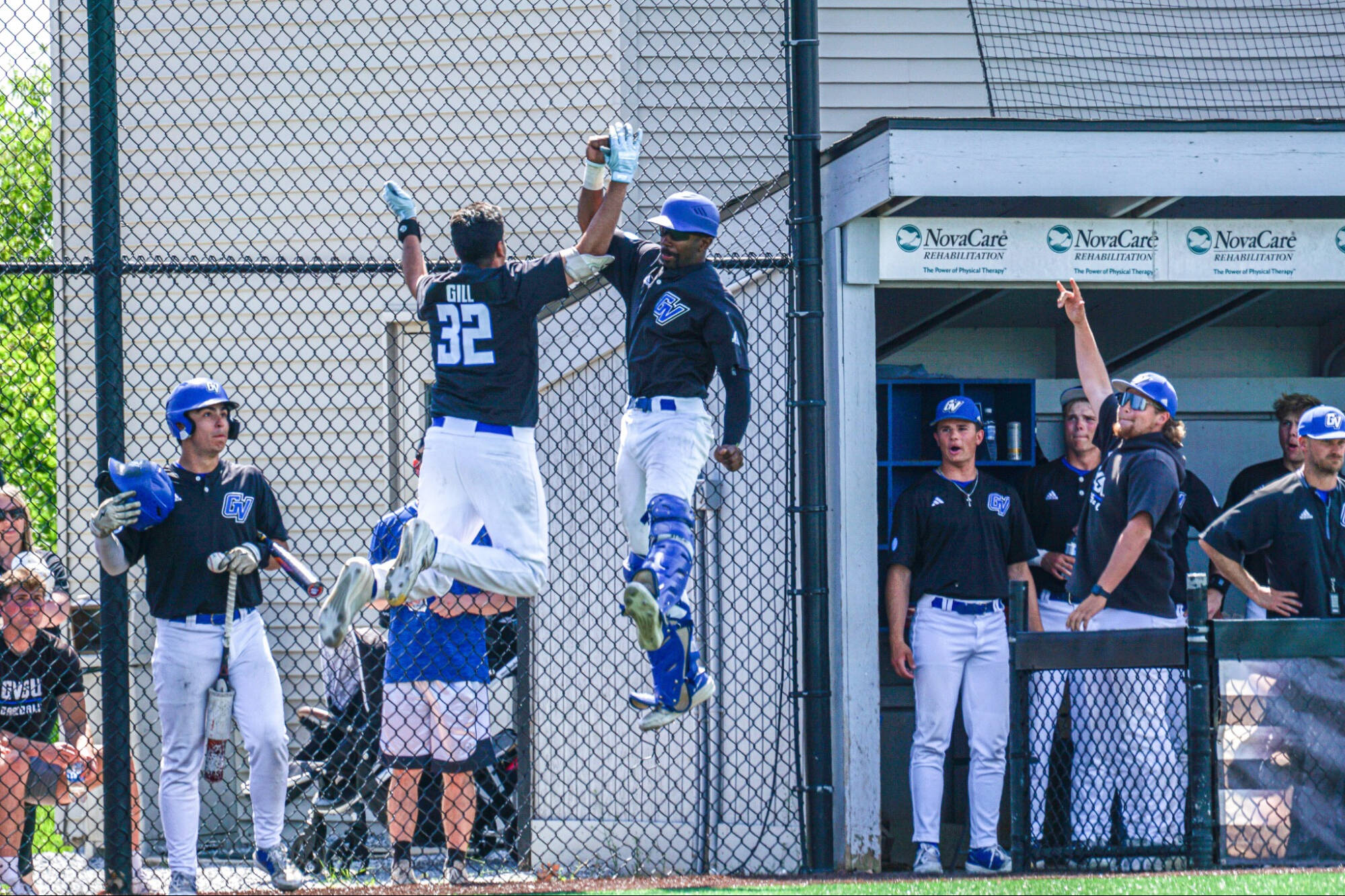 Men's Baseball high-five's in the air from 2026 season.